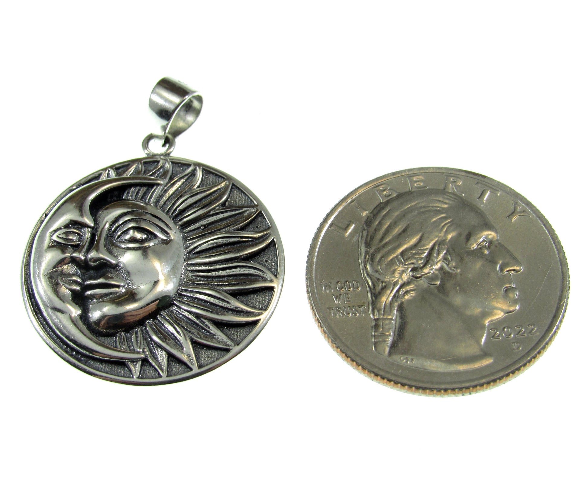 Roughly the same size as a US quarter, the crescent moon and sun faces pendant measures  1 5/16 inches including the bail.