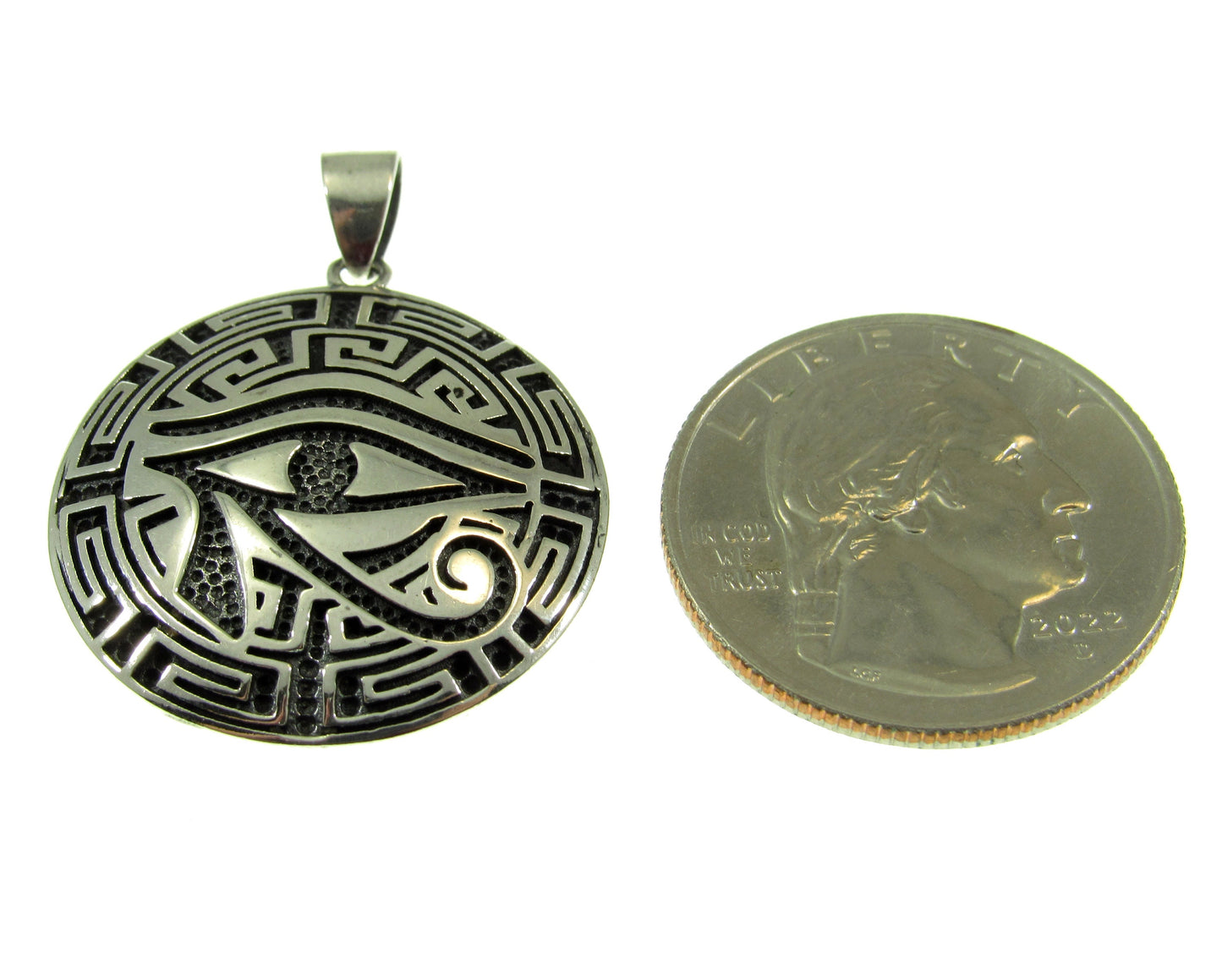Larger than a US quarter, the Greek key meander eye of Horus pendant measures 1 3/8 inches long by 1 inch wide