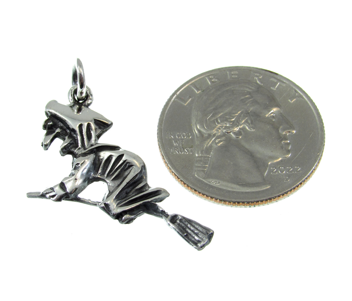 Roughly the size of a US Quarter, the wicked witch on broom pendant measures 1 7/16 long including the bail and 1 inch wide.