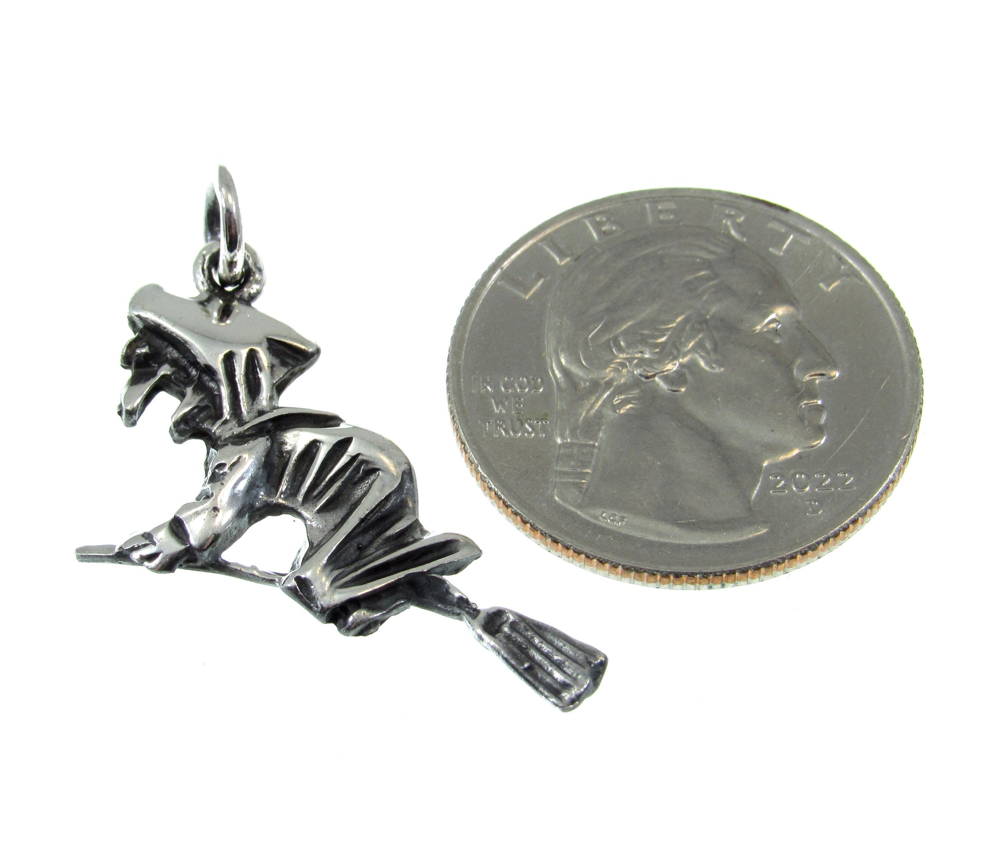 Roughly the size of a US Quarter, the wicked witch on broom pendant measures 1 7/16 long including the bail and 1 inch wide.
