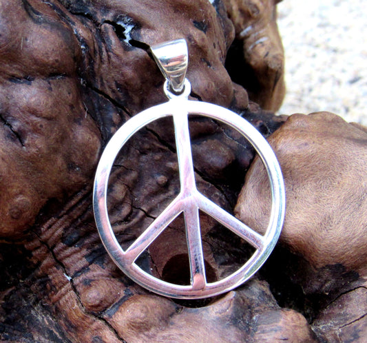 The pendant is a handcrafted solid 925 sterling silver peace sign symbol.