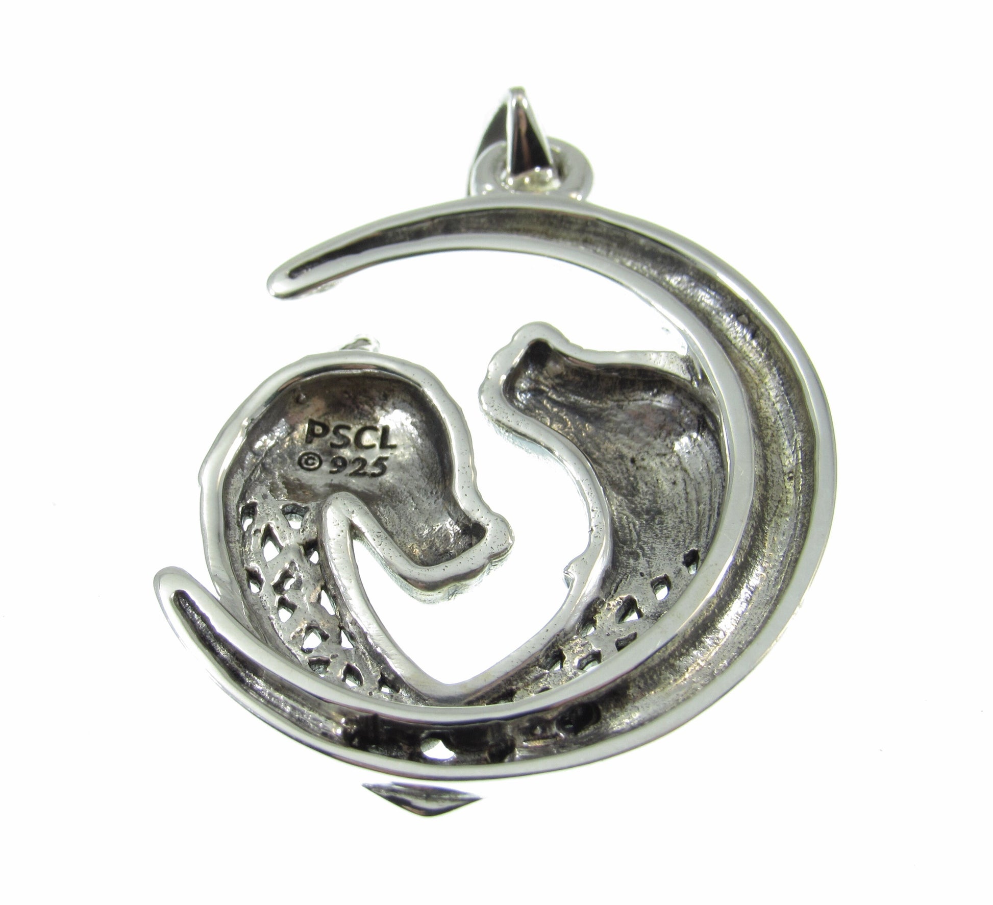 The solid silver double Celtic wolves pendant is hallmarked with Peter Stone's makers mark and quality stamped 925 for purity. It weighs 9 grams.