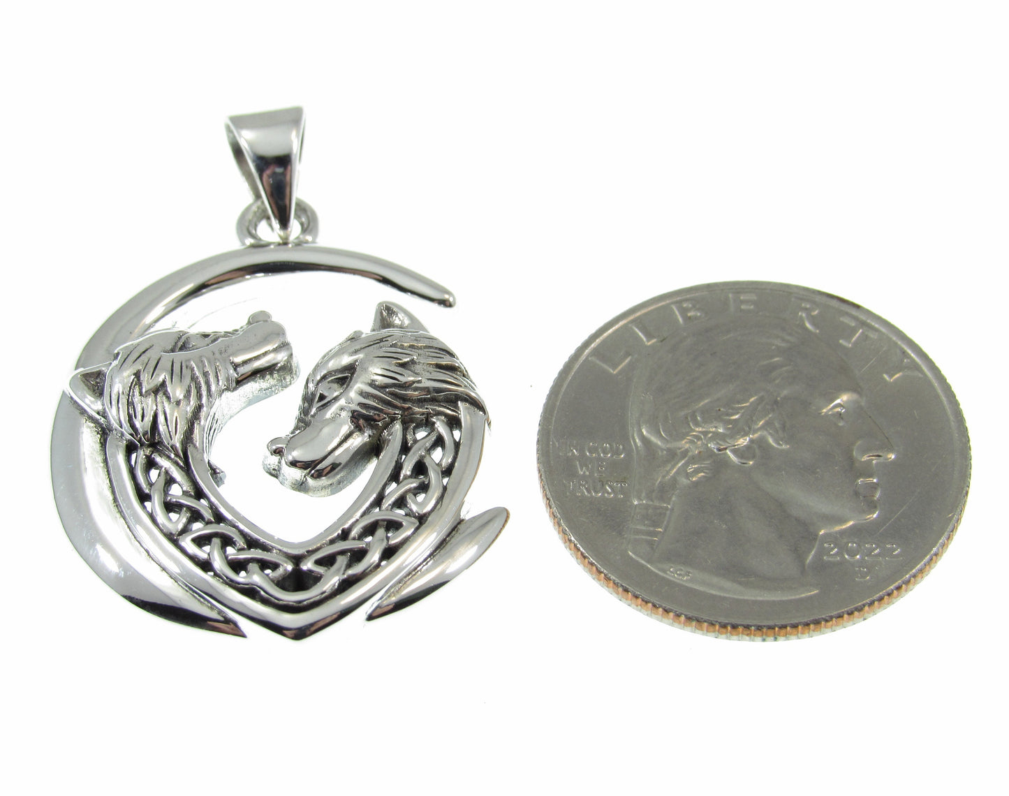 A bit larger than a US quarter, the solid sterling silver double Celtic wolves pendant measures 1 7/16 inches long by 1 inch wide.