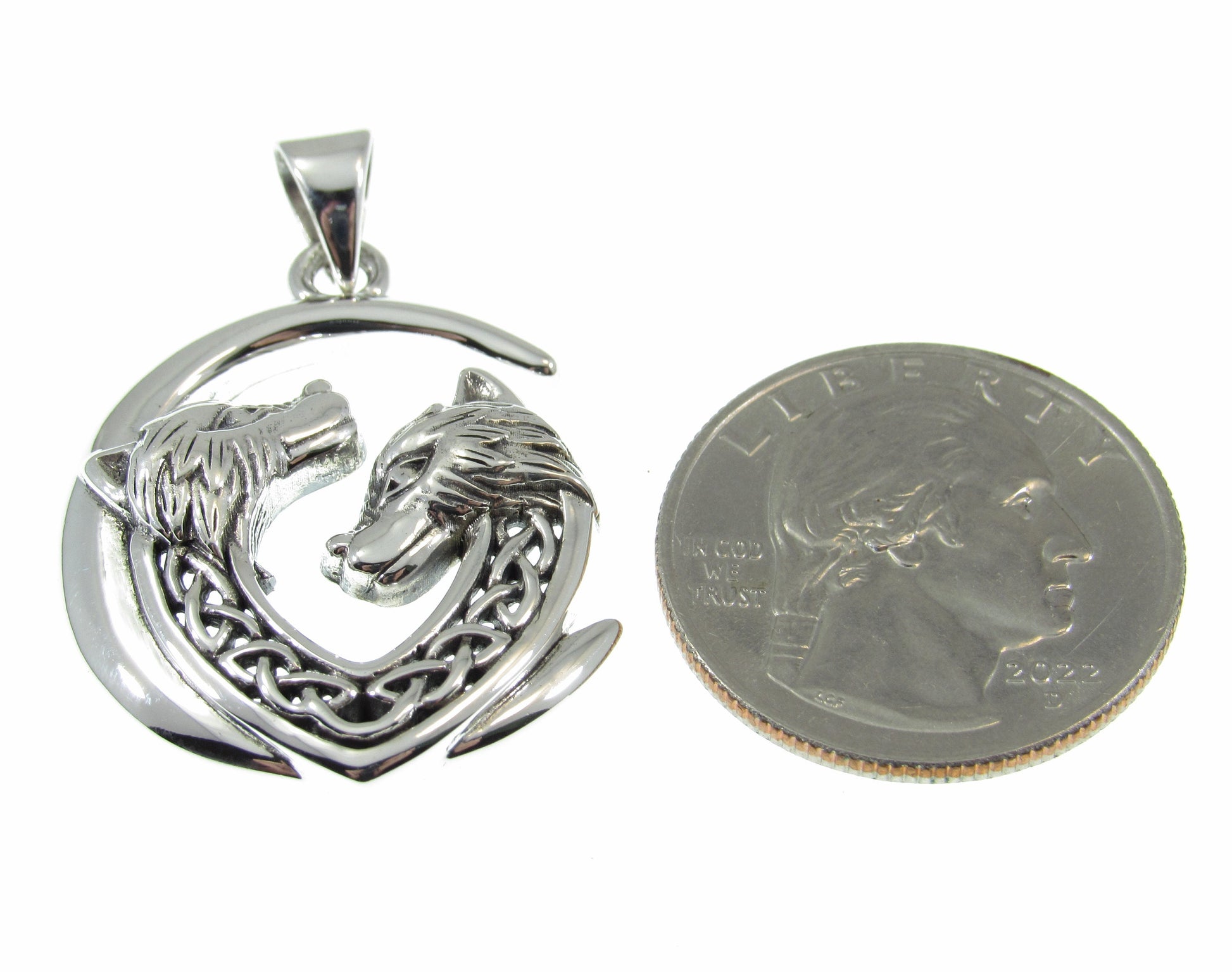 A bit larger than a US quarter, the solid sterling silver double Celtic wolves pendant measures 1 7/16 inches long by 1 inch wide.