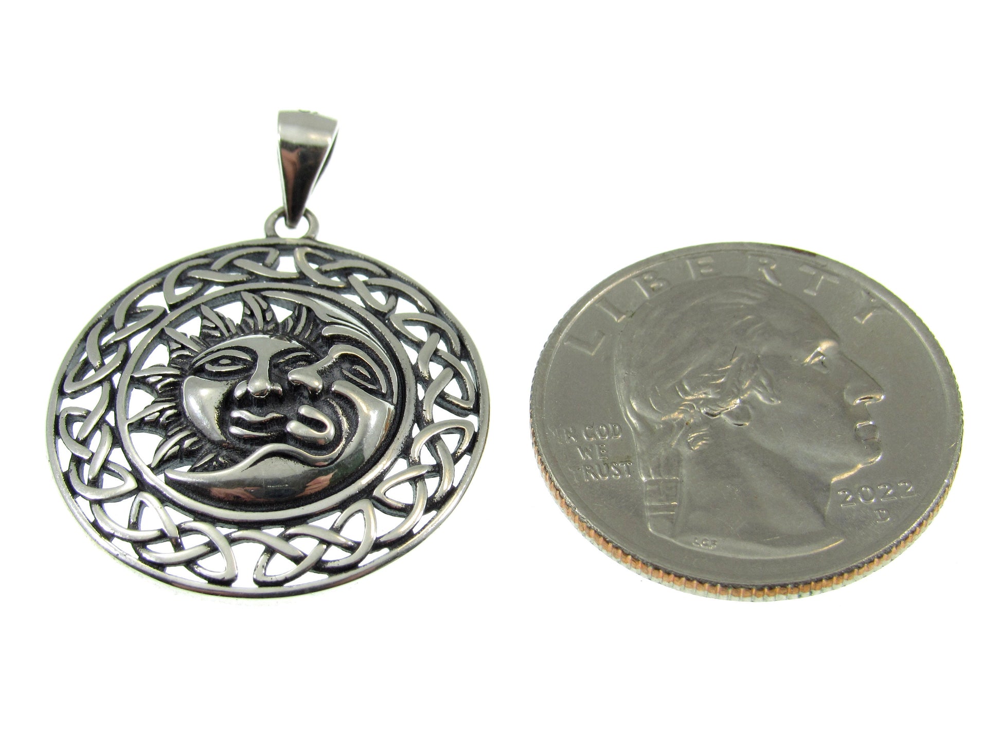Roughly the size of a US quarter, the Celtic sun and moon pendant measures 1 5/16 inches including the bail, and 1 inch wide.