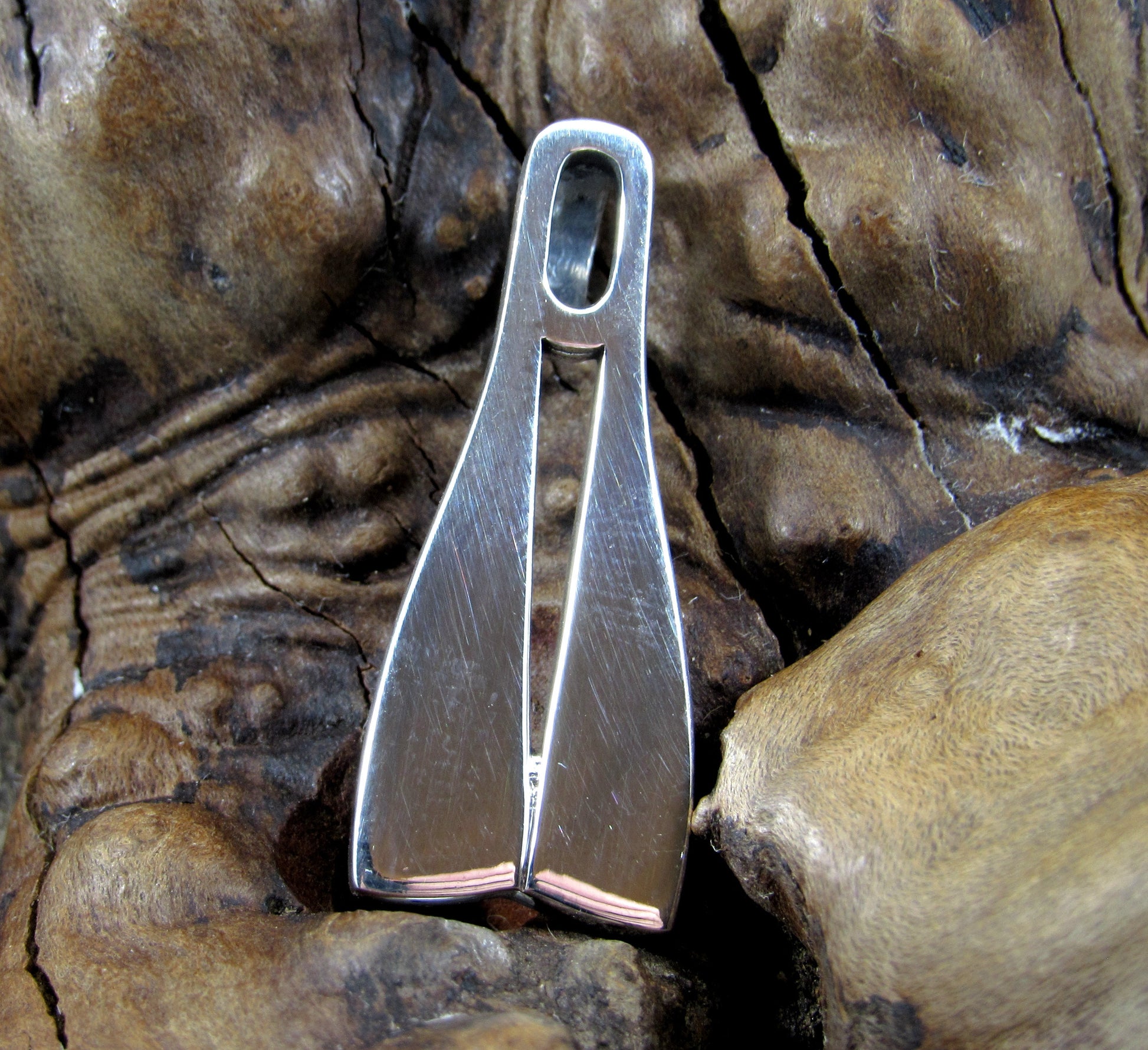 The double diving fin slide pendant is shaped like a pair of scuba diver fins and is handcrafted in solid sterling silver
